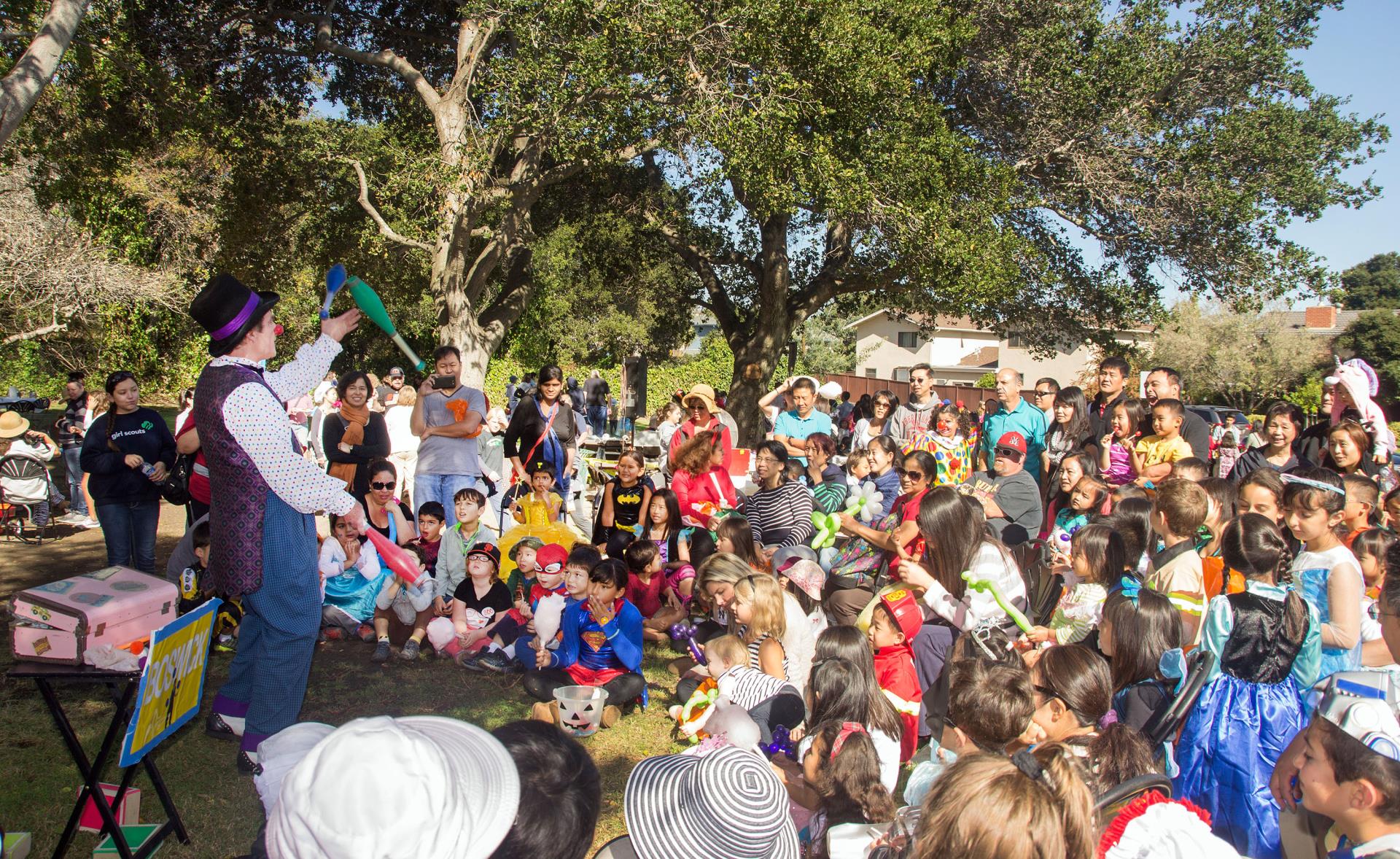 Children are entertained by a clown