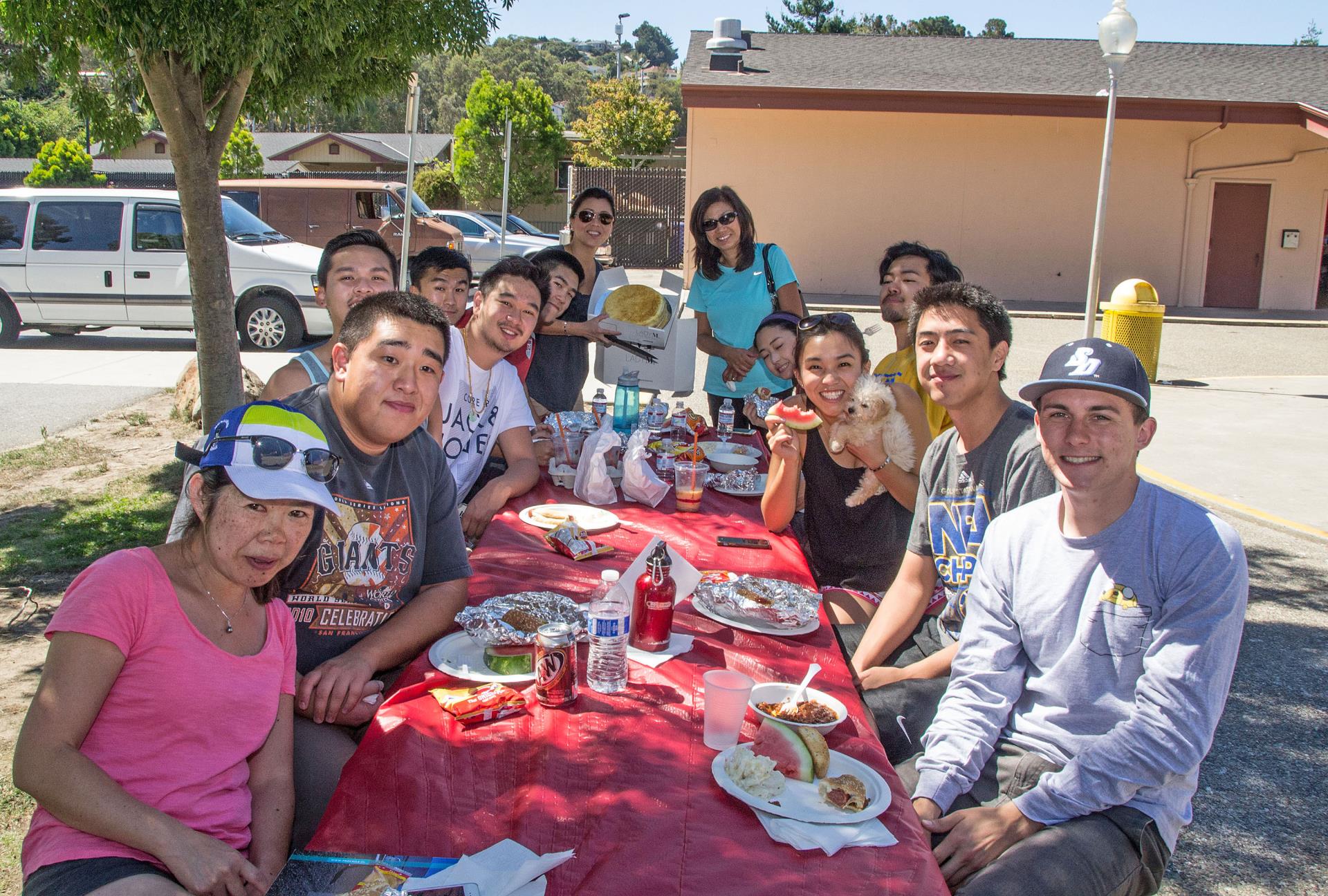 Participants enjoy great food and conversation outside on a picnic table